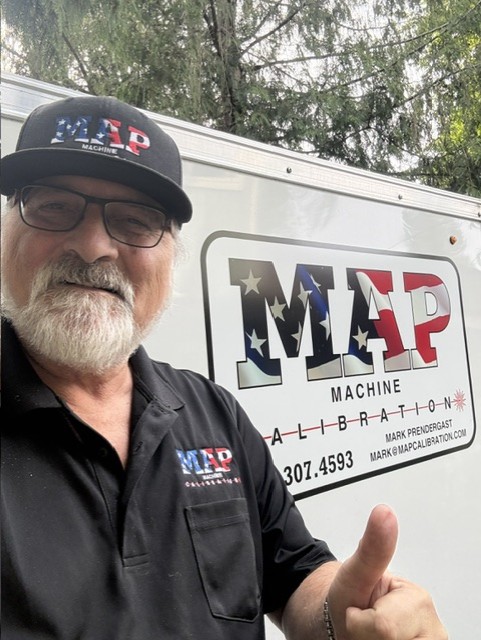 Mark Prendergast next to the MAP Machine Calibration service trailer